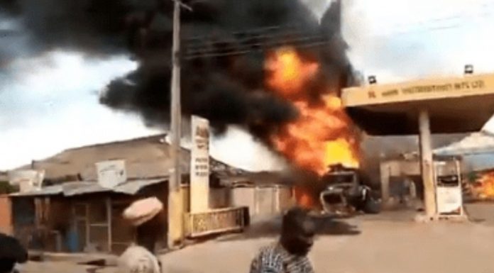 Petrol attendants extinguish burning minibus